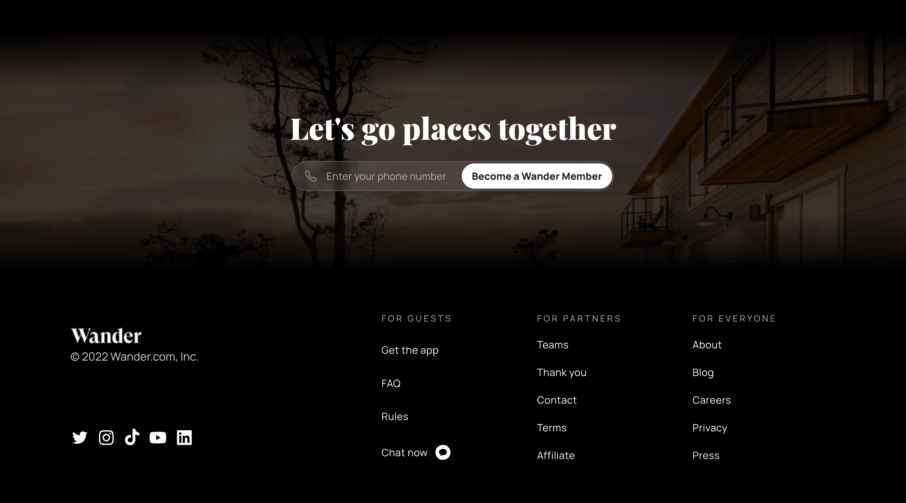 Footer section on the Wander homepage. The footer is split in two. To the right is a Wander logo with a copyright message and some social network icons. To the right are three columns with links to different areas on the website. Above the footer is a phone number opt-in field with a call to action to become a Wander member.